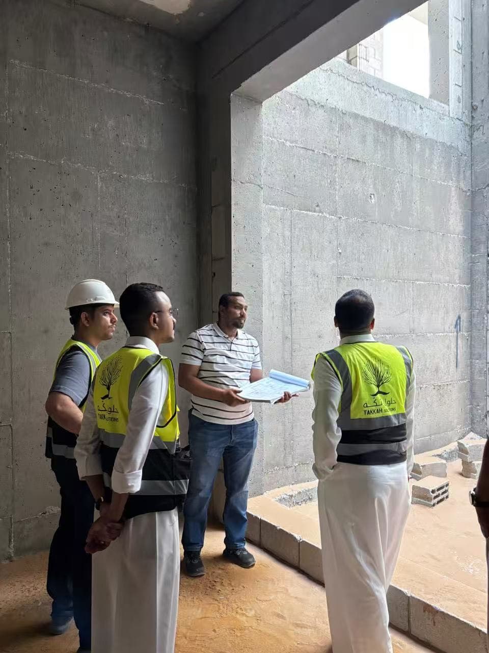 Takkah team reviewing plans with a project partner